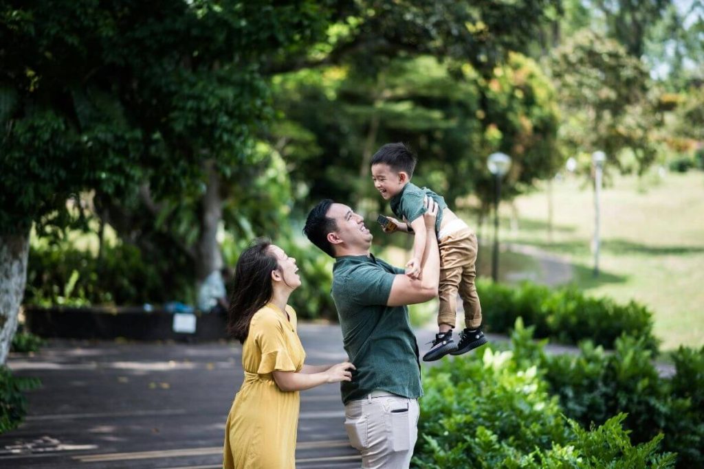 happy couple with their kid in singapore park